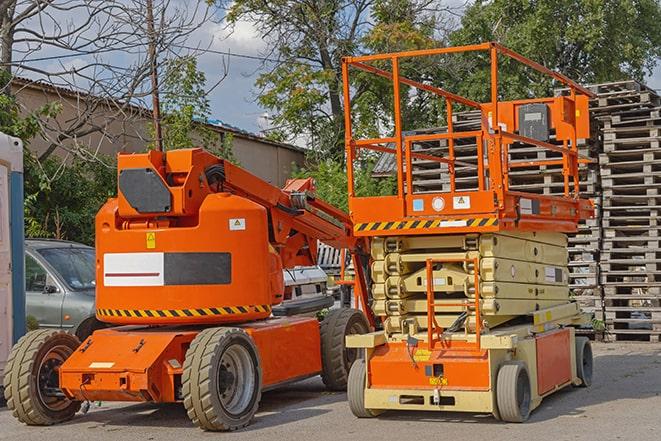 warehouse forklift in operation with stacked inventory in Ojus